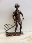 Brass farmer sculpture.